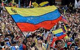 People cheer as they listen to Venezuela's National Assembly head Juan Guaido during a mass opposition rally against leader Nicolas Maduro in Caracas on January 23, 2019. (Federico Parra/AFP)