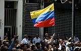 A crowd of opposition supporters listen to Venezuela's National Assembly head and the country's self-proclaimed "acting president" Juan Guaido (out of frame), at Bolivar Square in Chacao, eastern Caracas, on January 25, 2019. (Photo by Federico PARRA / AFP)