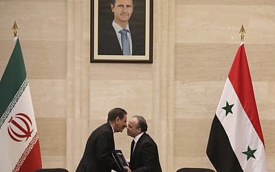 Syrian Prime Minister Imad Khamis, right, and Iranian Vice President Eshaq Jahangiri shake hands after the signing of an agreement in the capital Damascus on January 28, 2019. (LOUAI BESHARA / AFP)
