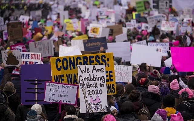 Demonstrators hold signs during the Women's March on January 19, 2019 in Washington, DC. Demonstrations are taking place in cities across the US in the third annual event aimed to highlight social change and celebrate women's rights around the world. ( Zach Gibson/Getty Images/AFP) Demonstrators hold signs during the Women's March on January 19, 2019 in Washington, DC. Demonstrations are taking place in cities across the US in the third annual event aimed to highlight social change and celebrate women's rights around the world. ( Zach Gibson/Getty Images/AFP)