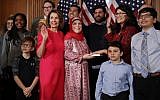 Rashida Tlaib (in red thobe and glasses), accompanied by her family, being sworn in with Speaker of the House Nancy Pelosi (in pink dress), at the US Capitol in Washington, DC, January 3, 2019. (Chip Somodevilla/Getty Images/AFP)