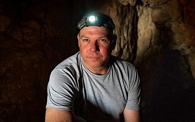 Researcher Oren Gutfeld inside Cave 52 at the Qumran archaeological site, January 22, 2019. (Luke Tress/Times of Israel)