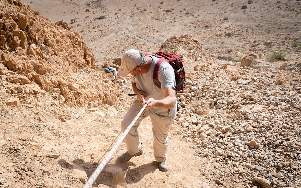 Researcher Oren Gutfeld descends from Cave 52, at the Qumran archaeological site, January 22, 2019. (Luke Tress/Times of Israel)