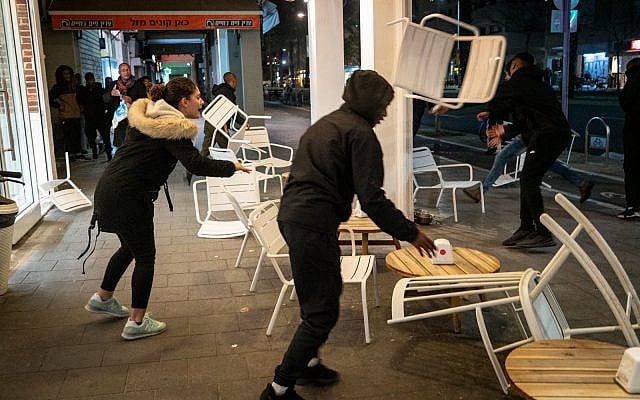 Ethiopian-Israeli protesters trash a sidewalk cafe on Ibn Gabriol Boulevard in Tel Aviv, January 30, 2019. (Luke Tress/Times of Israel) Ethiopian-Israeli protesters trash a sidewalk cafe on Ibn Gabriol Boulevard in Tel Aviv, January 30, 2019. (Luke Tress/Times of Israel)