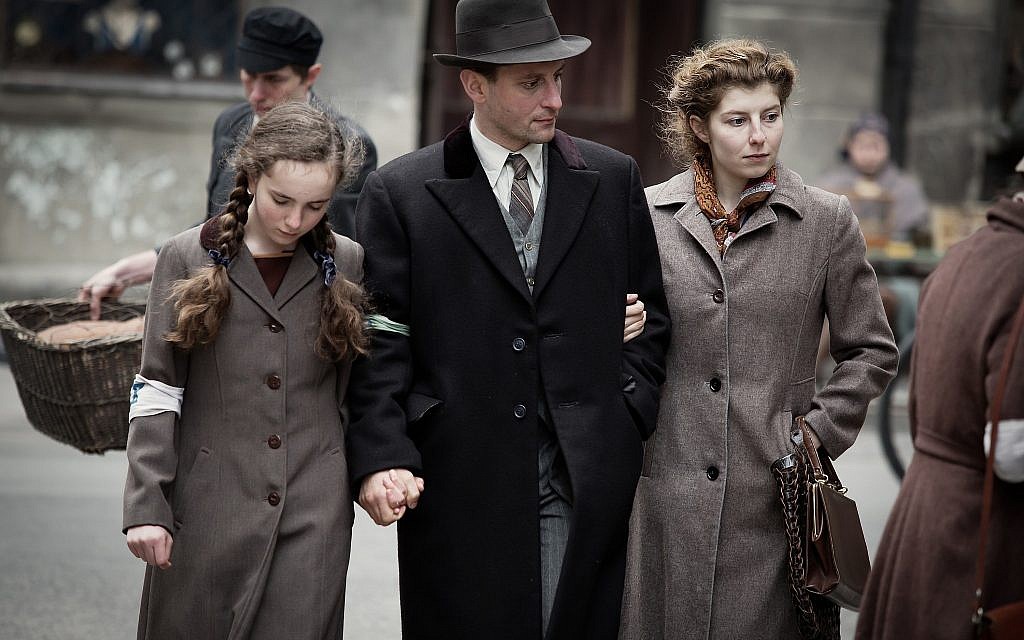 Julia Lewenfisz-Gorka, Wojciech Zielinski, and Marta Ormaniec portraying Ora, Abraham and Luba Lewin in a Ghetto street scene. (Anna Wloch/ Courtesy)