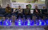 Palestinians soak their feet in tank stocked with fish at a cafe in Gaza City, December 26, 2018. (Khalil Hamra/AP)
