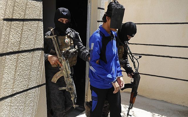 In this July 21, 2017, file photo, Kurdish soldiers from the Anti-Terrorism Units, carry a blindfolded an Indonesian man suspected of Islamic State membership, at a security center, in Kobani, Syria (AP Photo/Hussein Malla, File) In this July 21, 2017, file photo, Kurdish soldiers from the Anti-Terrorism Units, carry a blindfolded an Indonesian man suspected of Islamic State membership, at a security center, in Kobani, Syria (AP Photo/Hussein Malla, File)