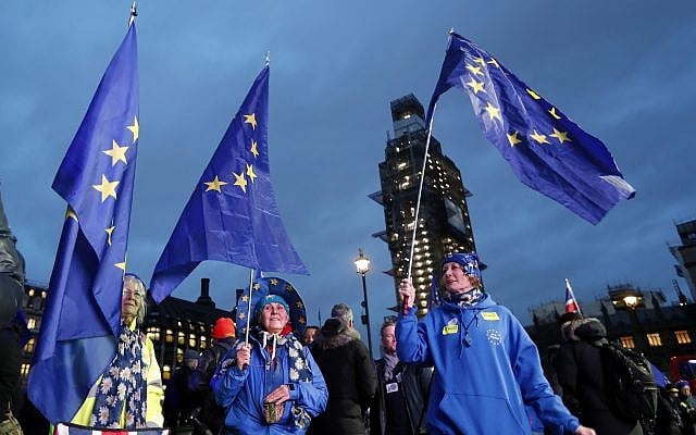 Pro-European demonstrators hold EU flags at Parliament Square in London, Tuesday, January 15, 2019. (AP Photo/Frank Augstein)