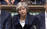 Britain's Prime Minister Theresa May listens to Labour leader Jeremy Corbyn speaking after losing a vote on her Brexit deal, in the House of Commons, London, Jan. 15, 2019 (House of Commons/PA via AP)