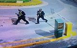 In this grab taken from security camera footage released to the local media, heavily armed attackers walk in the compound of a hotel, in Nairobi, Kenya, on January 15, 2019. (Security Camera Footage via AP)
