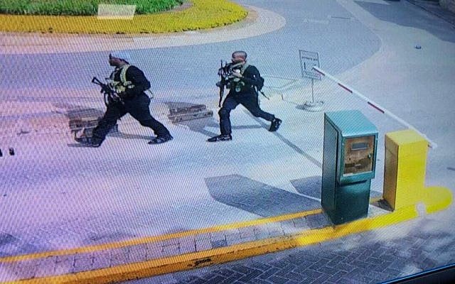In this grab taken from security camera footage released to the local media, heavily armed attackers walk in the compound of a hotel, in Nairobi, Kenya, on January 15, 2019. (Security Camera Footage via AP) In this grab taken from security camera footage released to the local media, heavily armed attackers walk in the compound of a hotel, in Nairobi, Kenya, on January 15, 2019. (Security Camera Footage via AP)