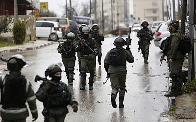 Illustrative: Israeli forces deploy during a raid in the West Bank City of Ramallah. January 9, 2019 (AP Photo/Majdi Mohammed, File)