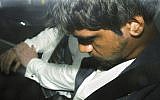 A 20-year-old man sits in a police car, January 18, 2019, after he is arrested for questioning over the death of Israeli student Aiia Maasarwe in Melbourne, Australia (James Ross/AAP Image via AP)
