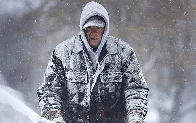 Gary Verstegen clears a sidewalk as a winter storm moves through Wisconsin on Monday, January 28, 2019, in Little Chute, Wisconsin. (William Glasheen/The Post-Crescent via AP)