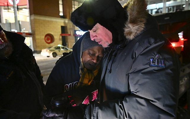 Pastor John Steger, with Grace In The City church in Minneapolis, Minnesota, embraces Jearline Cyrus, a homeless woman, in downtown Minneapolis, Tuesday, January 29, 2019, while delivering cold-weather gear, hot chocolate and food with Police Sgt. Grant Snyder. (Aaron Lavinsky/Star Tribune via AP) Pastor John Steger, with Grace In The City church in Minneapolis, Minnesota, embraces Jearline Cyrus, a homeless woman, in downtown Minneapolis, Tuesday, January 29, 2019, while delivering cold-weather gear, hot chocolate and food with Police Sgt. Grant Snyder. (Aaron Lavinsky/Star Tribune via AP)