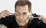 Israeli-British illusionist Uri Geller poses during the 24th MIPCOM (International Film and Programme Market for TV, Video,Cable and Satellitte) in Cannes, France, Oct 14, 2008. (AP Photo/Lionel Cironneau)