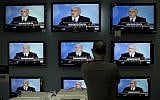 Illustrative: A man watches Prime Minister Benjamin Netanyahu making a speech on television screens at a shop in Jerusalem, on June 14, 2009. (AP/Bernat Armangue/File)