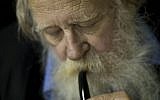 In this file photo taken on Nov. 10, 2010, Rabbi Adin Steinsaltz smokes a pipe during an interview with The Associated Press in Jerusalem. The 73-year-old rabbinical scholar had just completed a monumental 45-year project hailed in Jewish scholarly circles as a breakthrough of biblical proportions, the most comprehensive translation and commentary of the Talmud, with its 63 basic sections and nearly 6,000 pages. (AP Photo/Bernat Armangue, File)