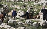 Illustrative: Jewish settlers throw stones near the West Bank village of Hawara, after five people were killed in the nearby Jewish settlement of Itamar Saturday, March 12, 2011. (AP Photo/Nasser Ishtayeh)