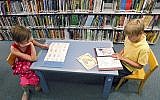 ILLUSTRATIVE -- In this photo taken on June 20, 2011, Nine year old Grace Powers, left, and her brother James, 11, read in the children's section at the Denver Public Library (AP Photo/Ed Andrieski)