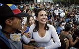 Opposition leader Maria Corina Machado, a former lawmaker, greets supporters during a vigil in honor of those who have been killed during clashes between security forces and demonstrators in Caracas, Venezuela, on July 31, 2017. (AP Photo/Ariana Cubillos)