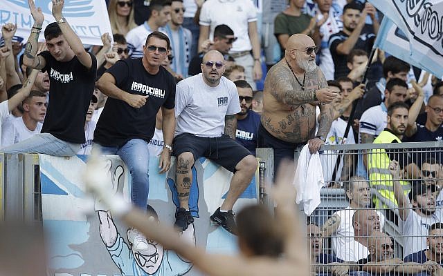 Lazio supporters celebrate at the end of a Serie A soccer match between Lazio and Genoa at Rome's Olympic stadium, September 23, 2018. (AP/Alessandra Tarantino) Lazio supporters celebrate at the end of a Serie A soccer match between Lazio and Genoa at Rome's Olympic stadium, September 23, 2018. (AP/Alessandra Tarantino)