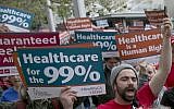 In the April 26, 2017 photo, supporters of single-payer health care march to the Capitol in Sacramento, Calif. (AP Photo/Rich Pedroncelli)