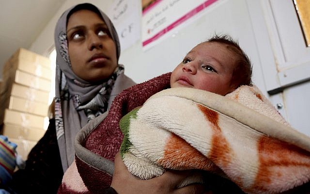 A Syrian child from the informal Rukban camp for displaced Syrians, between the Jordan and Syria borders, receives treatment in a clinic run by UNICEF inside Jordan, February 14, 2017. (Raad Adayleh/AP) A Syrian child from the informal Rukban camp for displaced Syrians, between the Jordan and Syria borders, receives treatment in a clinic run by UNICEF inside Jordan, February 14, 2017. (Raad Adayleh/AP)