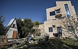 In this photo from January 17, 2016, Moshe Gordon sits outside his guest house advertised on the Airbnb international home-sharing site in Nofei Prat settlement in the West Bank. (AP Photo/Tsafrir Abayov, File)