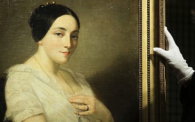The painting 'Portrait of a Seated Young Woman' by Thomas Couture stands on a easel during a restitution ceremony to the heirs of Jewish French politician Georges Mandel in Berlin on January 8, 2019. (AP Photo/Markus Schreiber)