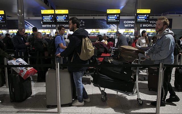 Passengers wait in a queue in departures at Heathrow Airport in London, Tuesday, Jan. 8, 2019. London's Heathrow Airport briefly halted departing flights on Tuesday after a reported drone sighting — a development that came just three weeks after multiple reports of drone sightings caused travel chaos at nearby Gatwick Airport. (Yui Mok/PA via AP) Passengers wait in a queue in departures at Heathrow Airport in London, Tuesday, Jan. 8, 2019. London's Heathrow Airport briefly halted departing flights on Tuesday after a reported drone sighting — a development that came just three weeks after multiple reports of drone sightings caused travel chaos at nearby Gatwick Airport. (Yui Mok/PA via AP)