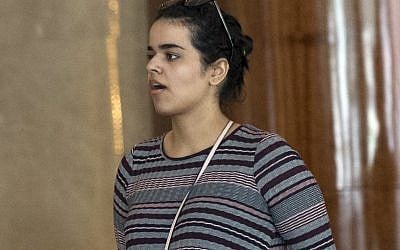 Rahaf Mohammed Alqunun walks in Bangkok, Thailand, Friday, Jan. 11, 2019. Alqunun, the 18-year old Saudi woman who fled her family to seek asylum, remains in Thailand under the care of the UN refugee agency as she awaits a decision by a third country to accept her as a refugee. (AP Photo/Sakchai Lalit)