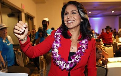 In this Nov. 6, 2018, file photo, Rep. Tulsi Gabbard, D-Hawaii, greets supporters in Honolulu (AP Photo/Marco Garcia, File)