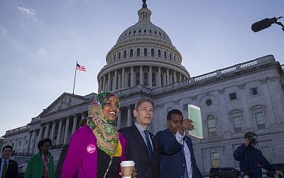 Rep. Ilhan Omar, D-Minn., left, Rep. Tom Malinowski, D-N.J., Rep. Joe Neguse, D-Colo., and other freshmen members of the House of Representatives walk to the Senate side to speak about the government shutdown on Capitol Hill, Tuesday, Jan. 15, 2019 in Washington. (AP Photo/Alex Brandon)