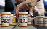 In this Aug. 17, 2018 photo, family and friends who have lost loved ones to OxyContin and opioid overdoses leave pill bottles in protest outside the headquarters of Purdue Pharma, which is owned by the Sackler family, in Stamford, Conn. (AP/Jessica Hill)