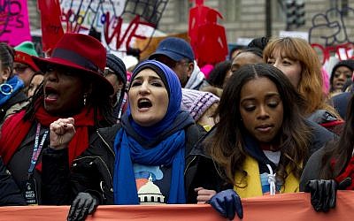 Co-presidents of the 2019 Women's March, Linda Sarsour, center, and Tamika Mallory, right, join other demonstrators on Pennsylvania Avenue during the Women's March in Washington on Saturday, January 19, 2019. (AP Photo/Jose Luis Magana)