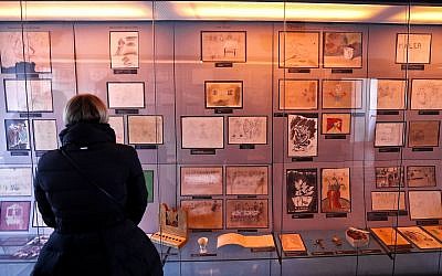 A visitor looks at the collection of drawings at the Jewish Museum in Prague, Czech Republic, Jan. 24, 2019, made by Jewish children who passed through the Terezin Ghetto during WWII (AP Photo/Petr David Josek)