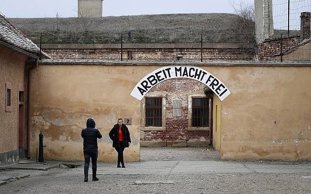 Visitors take photographs at the former Nazi concentration camp in Terezin, Czech Republic, Thursday, Jan. 24, 2019 (AP Photo/Petr David Josek)