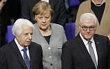From left, Israeli Historian Saul Friedlander, German Chancellor Angela Merkel and German President Frank-Walter Steinmeier arrive for a remembrance event of the parliament Bundestag to commemorate the victims of the Holocaust at the Reichstag building in Berlin, January 31, 2019. (AP Photo/Markus Schreiber)