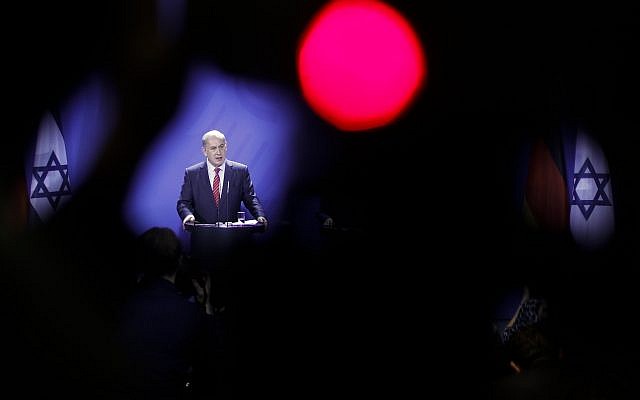 In this photo taken with a red television camera control light in the foreground, Prime Minister Benjamin Netanyahu attends a news conference with German Chancellor Angela Merkel during a meeting at the chancellery in Berlin, October 21, 2015. (AP/Markus Schreiber) In this photo taken with a red television camera control light in the foreground, Prime Minister Benjamin Netanyahu attends a news conference with German Chancellor Angela Merkel during a meeting at the chancellery in Berlin, October 21, 2015. (AP/Markus Schreiber)