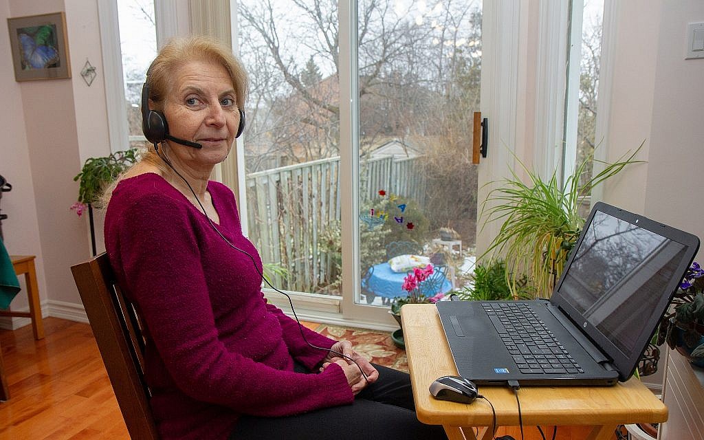 ERAN volunteer Irit Toni takes calls from Israel on her laptop at her Toronto home. (Etye Sarner)