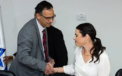Newly appointed Justice MinisterAyelet Shaked (R) shakes hands with State Prosecutor Shai Nitzan during a ceremony at the Justice Ministry in Jerusalem on May 17, 2015. (Dudi Vaknin/pool)