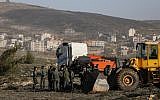 IDF forces seen at the illegal outpost of Amona in the West Bank on January 3, 2019. (Yonatan Sindel/Flash90)