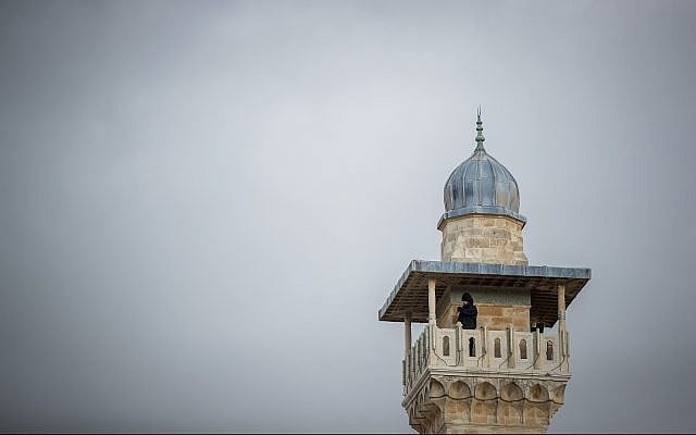A man looks out from a minaret at the Al-Aqsa Mosque in the Old City of Jerusalem on January 23, 2018. (Yonatan Sindel/Flash90) A man looks out from a minaret at the Al-Aqsa Mosque in the Old City of Jerusalem on January 23, 2018. (Yonatan Sindel/Flash90)