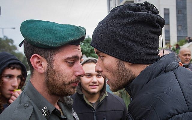 Right wing activists clash with police outside a court hearing in Rishon Lezion, on the matter of the Jewish youth suspects in a major security probe whose details are under gag order on December 31, 2018. (Flash90) Right wing activists clash with police outside a court hearing in Rishon Lezion, on the matter of the Jewish youth suspects in a major security probe whose details are under gag order on December 31, 2018. (Flash90)