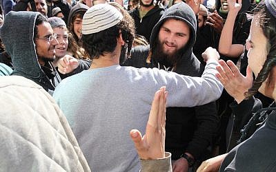 A suspect in the killing of Aisha Rabi is embraced by a supporter outside the Rishon Lezion Magistrate's Court after being released to house arrest on January 10, 2019. (Flash90)