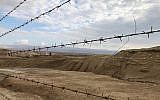 A view of the minefields outside the Qaser al-Yahud Baptism Site in the Judean Desert on the border with the Jordan River on the Eastern Orthodox holiday of Epiphany on January 18, 2019. (Amanda Borschel-Dan/Times of Israel)