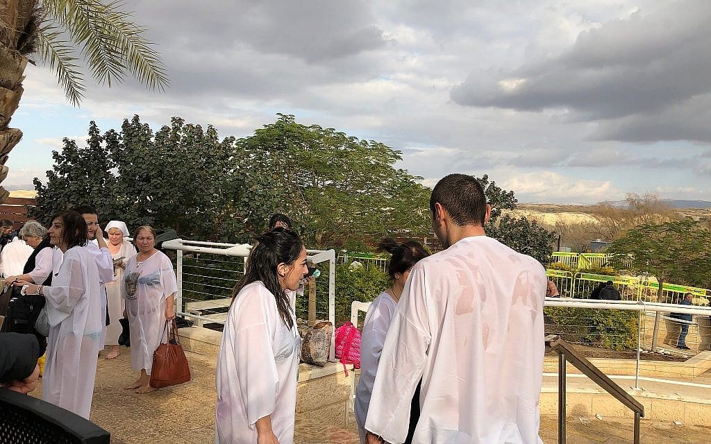 Pilgrims post-baptism at the Qaser al-Yahud Baptism Site in the Judean Desert on the border with the Jordan River on the Eastern Orthodox holiday of Epiphany on January 18, 2019. (Amanda Borschel-Dan/Times of Israel)