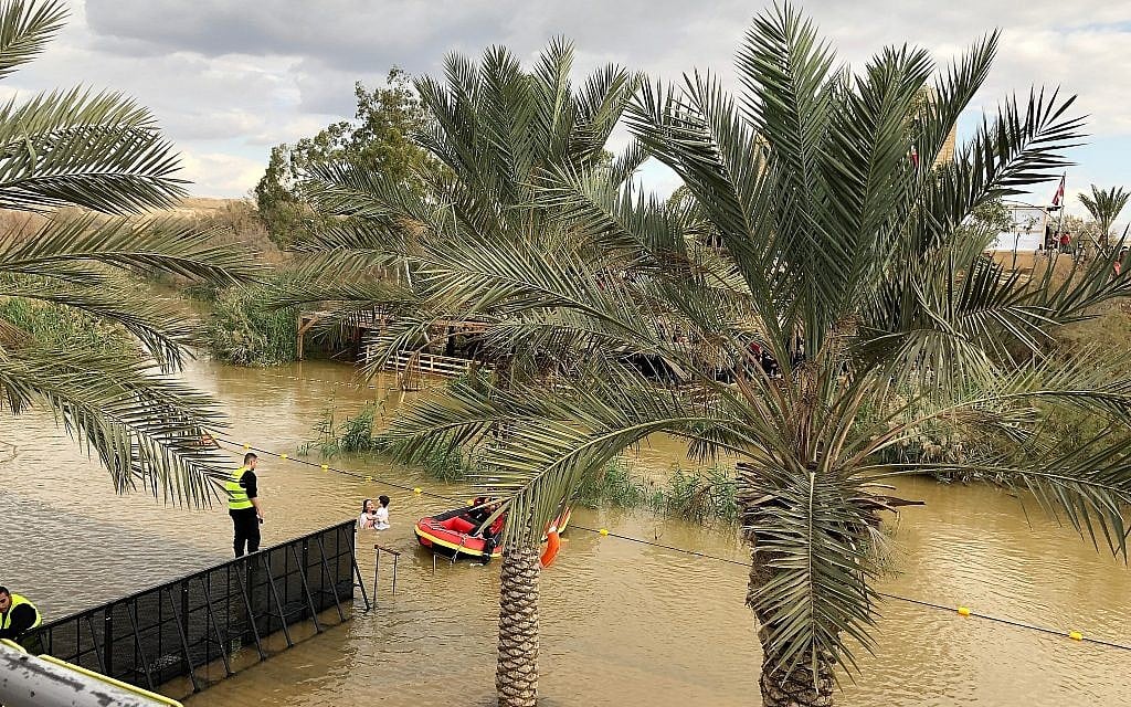 A pilgrim and her son are baptised at the Qaser al-Yahud Baptism Site in the Judean Desert on the border with the Jordan River on the Eastern Orthodox holiday of Epiphany on January 18, 2019. (Amanda Borschel-Dan/Times of Israel)