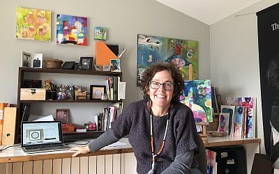 Artist Susie Lubell at her Tsur Hadassah rooftop studio, where she creates collages and ketubot sold on her online stores (Jessica Steinberg/Times of Israel)